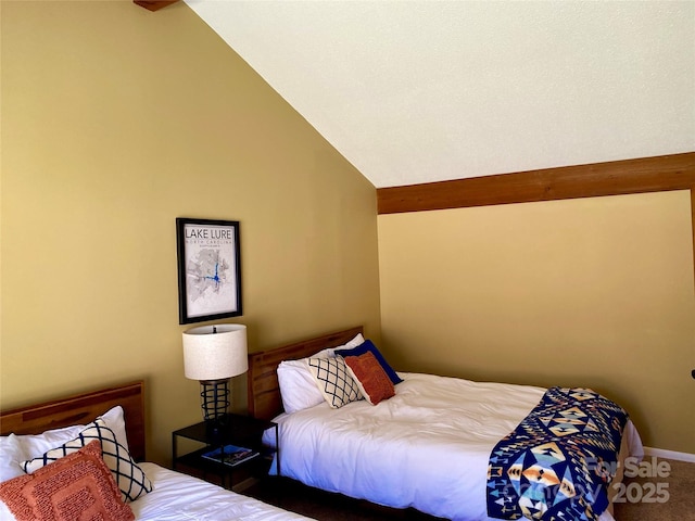 carpeted bedroom with vaulted ceiling