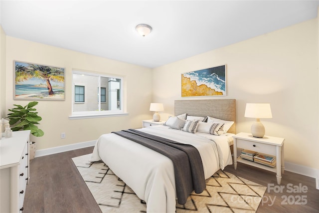 bedroom with baseboards and wood finished floors