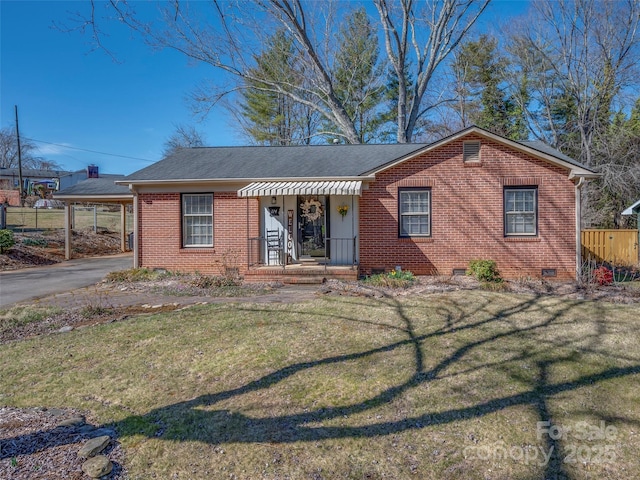 ranch-style house with brick siding, a front yard, crawl space, fence, and a carport