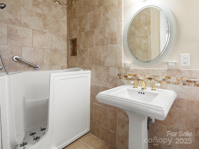 bathroom with tile patterned flooring and tile walls