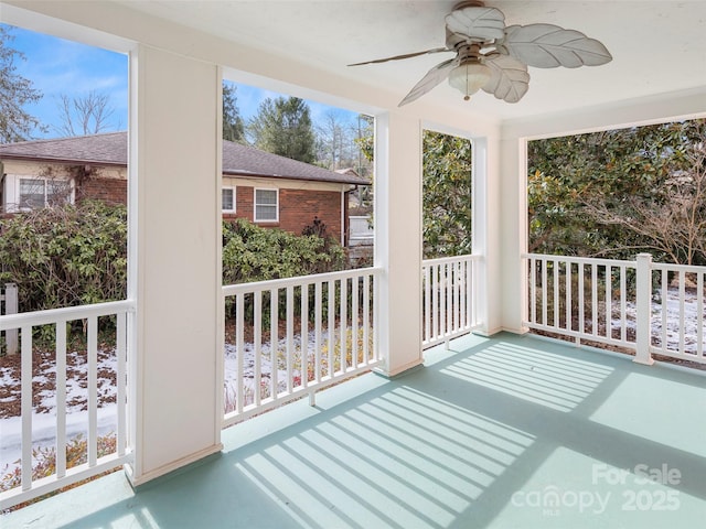 unfurnished sunroom with a ceiling fan