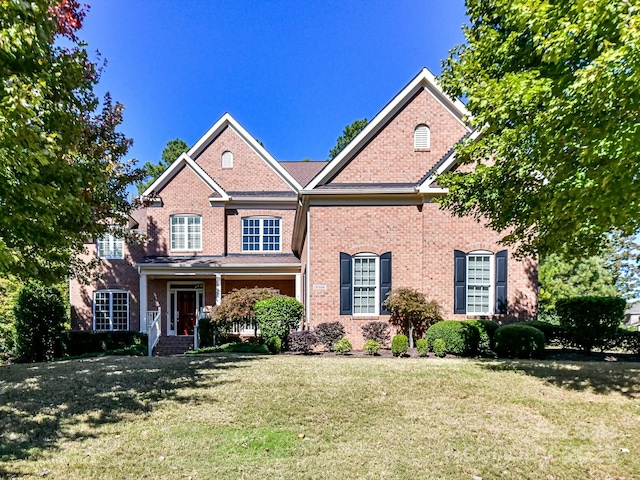 traditional-style house with brick siding and a front yard