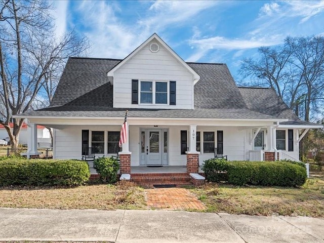 view of front of home with a shingled roof and covered porch