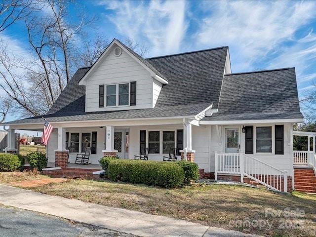 view of front of home featuring a porch and roof with shingles