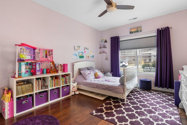 bedroom featuring visible vents, a ceiling fan, and wood finished floors