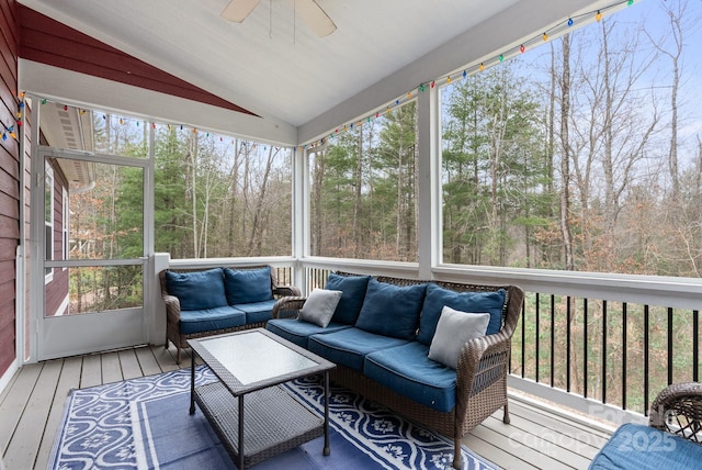 sunroom / solarium with lofted ceiling and ceiling fan