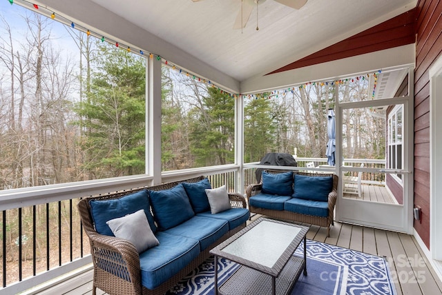 sunroom / solarium with plenty of natural light, ceiling fan, and lofted ceiling