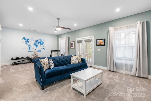 living room with light carpet, recessed lighting, french doors, and baseboards