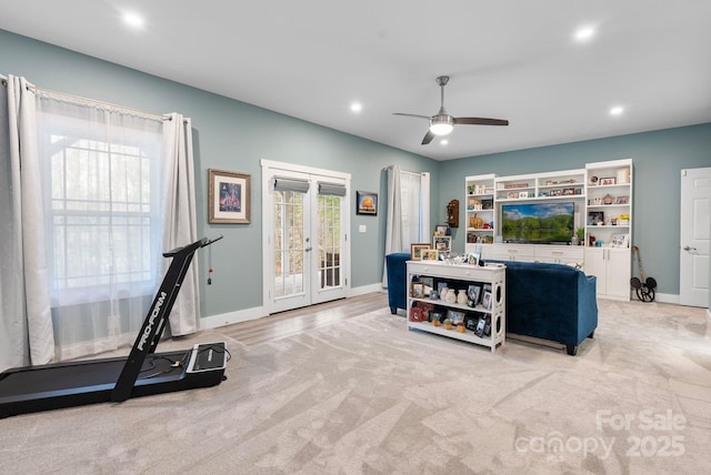 exercise room with baseboards, light colored carpet, recessed lighting, french doors, and a ceiling fan