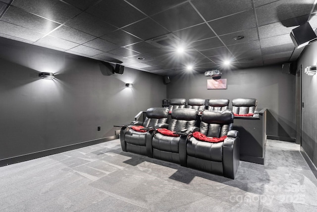 cinema featuring carpet flooring, baseboards, and a drop ceiling