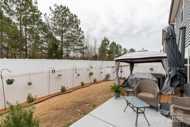 view of patio / terrace with a fenced backyard and a gazebo