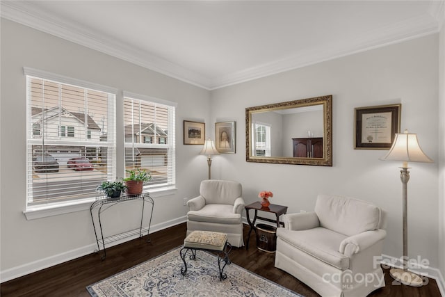 living area featuring baseboards, wood finished floors, and ornamental molding