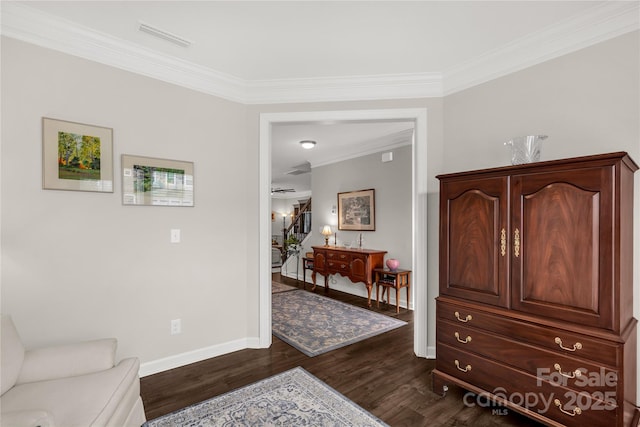 living area featuring baseboards, visible vents, dark wood-type flooring, stairs, and crown molding