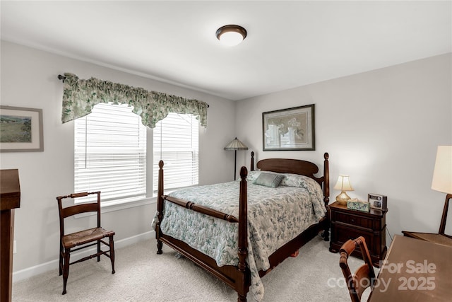 bedroom with light carpet and baseboards