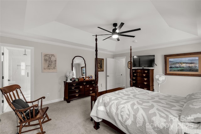 bedroom featuring ornamental molding, a tray ceiling, and light colored carpet