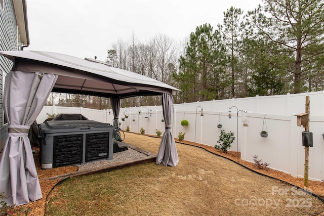 view of yard featuring a gazebo and a fenced backyard