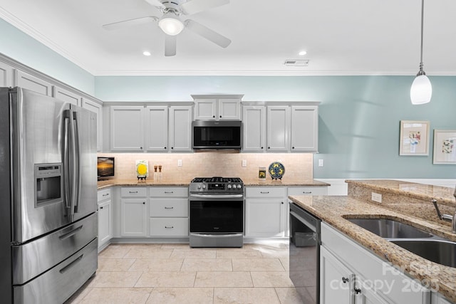 kitchen featuring light stone countertops, stainless steel appliances, white cabinets, decorative backsplash, and pendant lighting