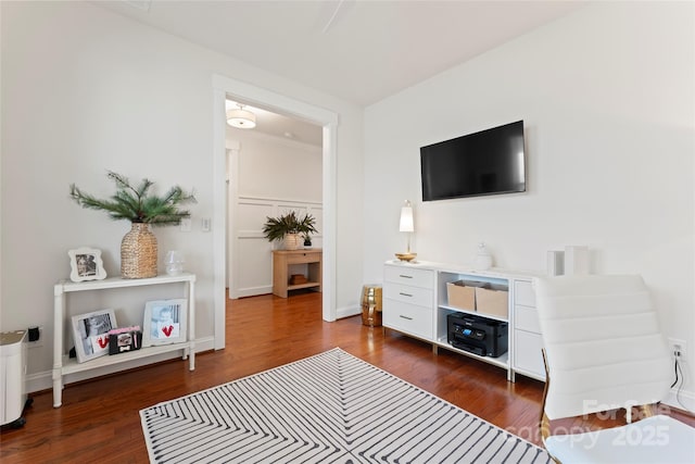 sitting room featuring baseboards and dark wood finished floors