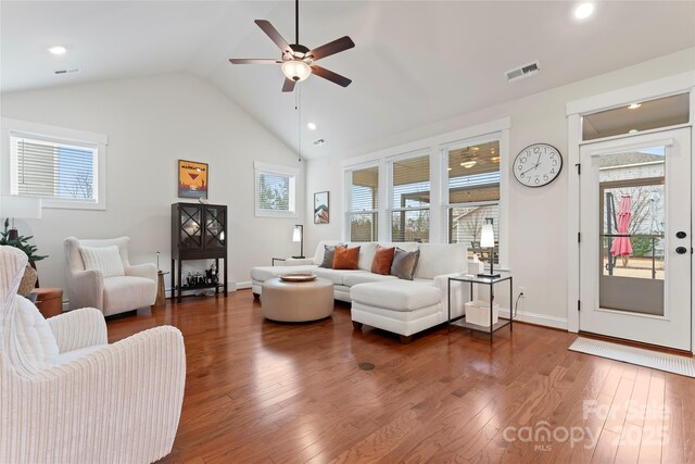 living area with dark wood-style floors, baseboards, visible vents, and a ceiling fan