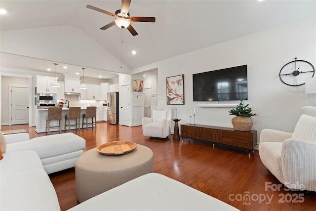 living room featuring high vaulted ceiling, a ceiling fan, and wood finished floors