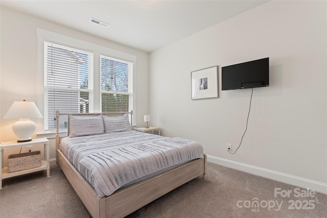 bedroom with carpet floors, visible vents, and baseboards