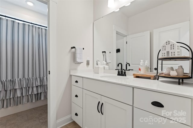 bathroom featuring a shower with shower curtain, tile patterned flooring, and vanity