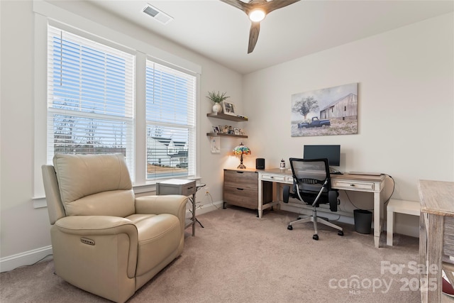 carpeted office with a ceiling fan, visible vents, and baseboards