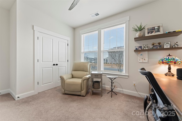 office space featuring light carpet, visible vents, and baseboards