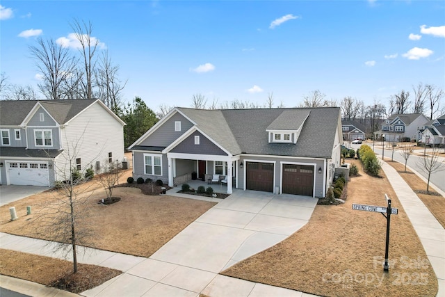 traditional home with a porch, a residential view, driveway, and fence