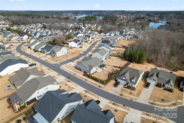 drone / aerial view with a water view and a residential view