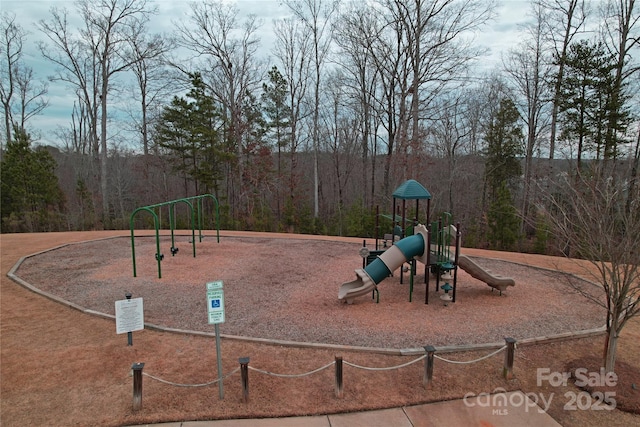 community play area featuring a view of trees