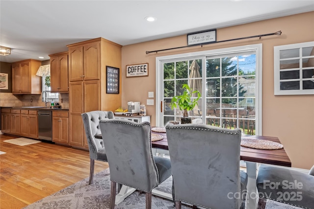 dining space with light wood-type flooring and recessed lighting