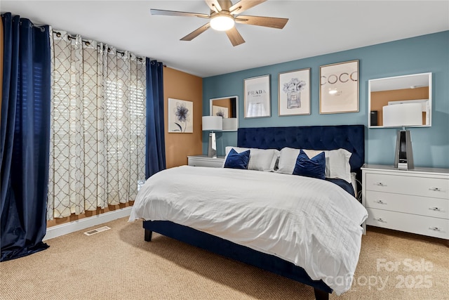 carpeted bedroom with visible vents, ceiling fan, and baseboards