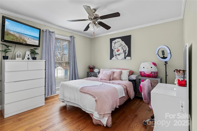 bedroom with ornamental molding, ceiling fan, and light wood-style flooring