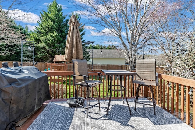 deck featuring a fenced backyard and a grill