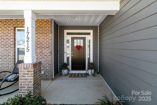 property entrance with brick siding