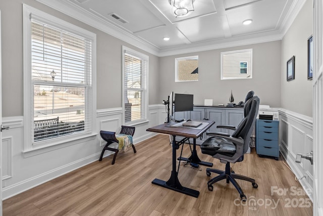 office space with visible vents, coffered ceiling, wainscoting, crown molding, and light wood-type flooring