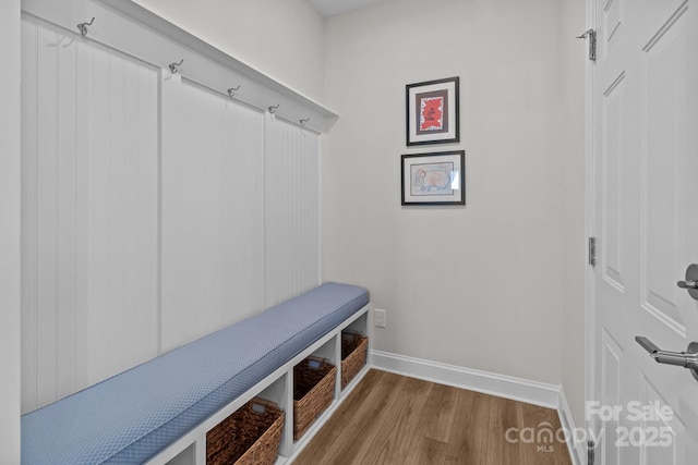 mudroom with baseboards and wood finished floors