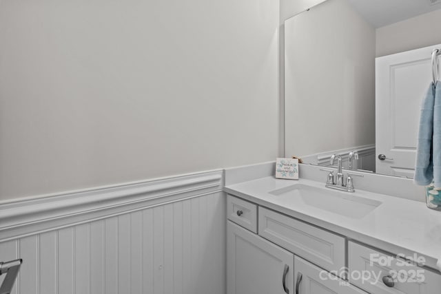 bathroom with a wainscoted wall and vanity