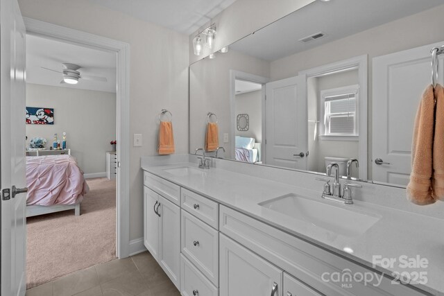 ensuite bathroom featuring a sink, connected bathroom, and visible vents