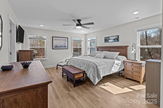 bedroom with light wood-style flooring, multiple windows, visible vents, and recessed lighting