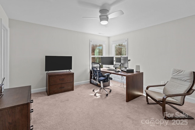 office space featuring light carpet, ceiling fan, and baseboards