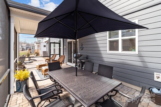 view of patio with outdoor dining space and grilling area