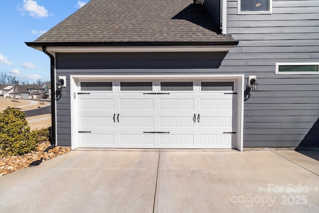 garage with concrete driveway