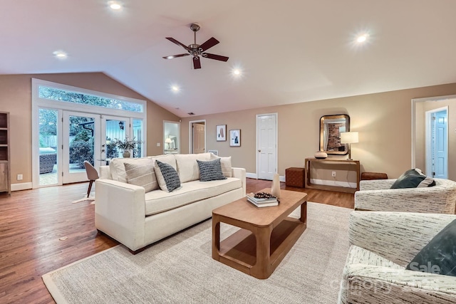 living area with wood finished floors, recessed lighting, french doors, baseboards, and vaulted ceiling