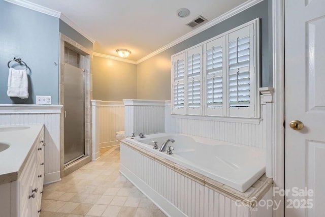 bathroom with vanity, a wainscoted wall, a stall shower, ornamental molding, and a bath