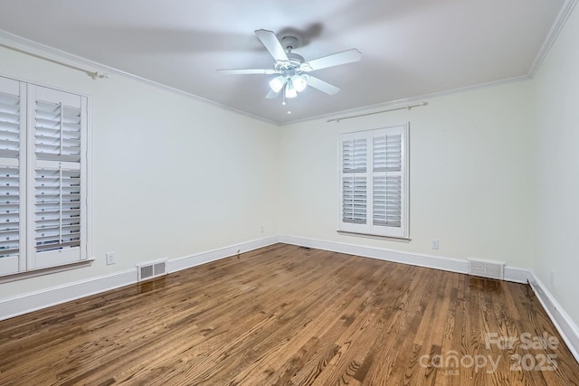 spare room featuring visible vents, crown molding, a ceiling fan, and wood finished floors