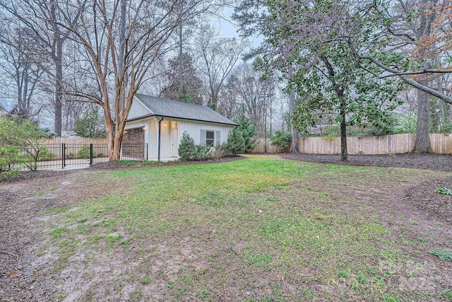 view of yard with a garage, an outdoor structure, and fence