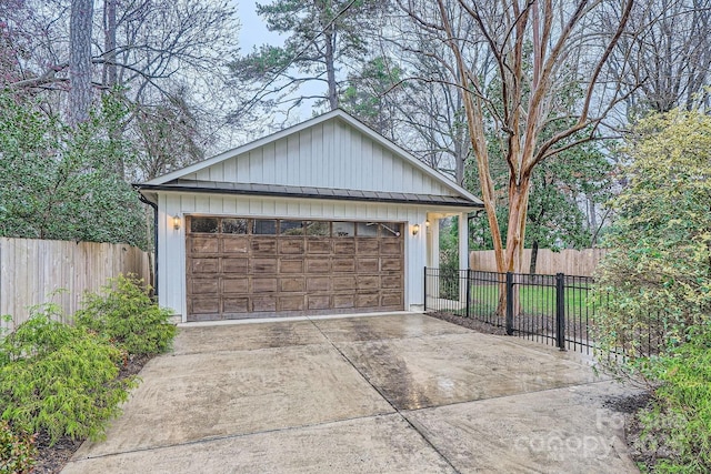 detached garage featuring fence