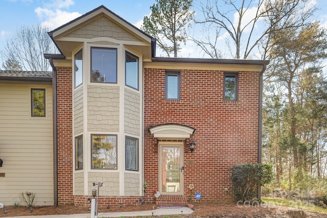 view of front of house with entry steps and brick siding